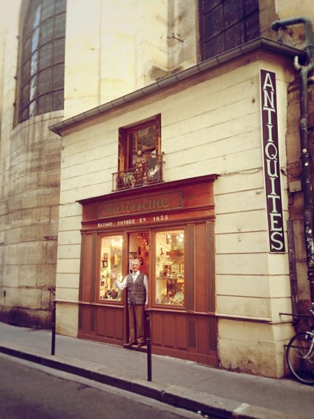 The Tiniest Antique Shop in Paris is stuck to the side of a Church (and sells fresh Eggs)