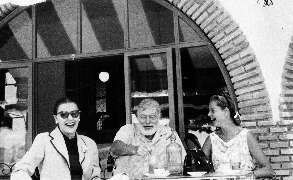 EH4474P ca. 1950's Ernest Hemingway, Lauren Bacall, and Veronica Cooper (also known as Rock Cooper) drinking in a cafe. Cuba. Copyright unknown. Please credit: "Ernest Hemingway Collection in the John F. Kennedy Presidential Library and Museum, Boston"