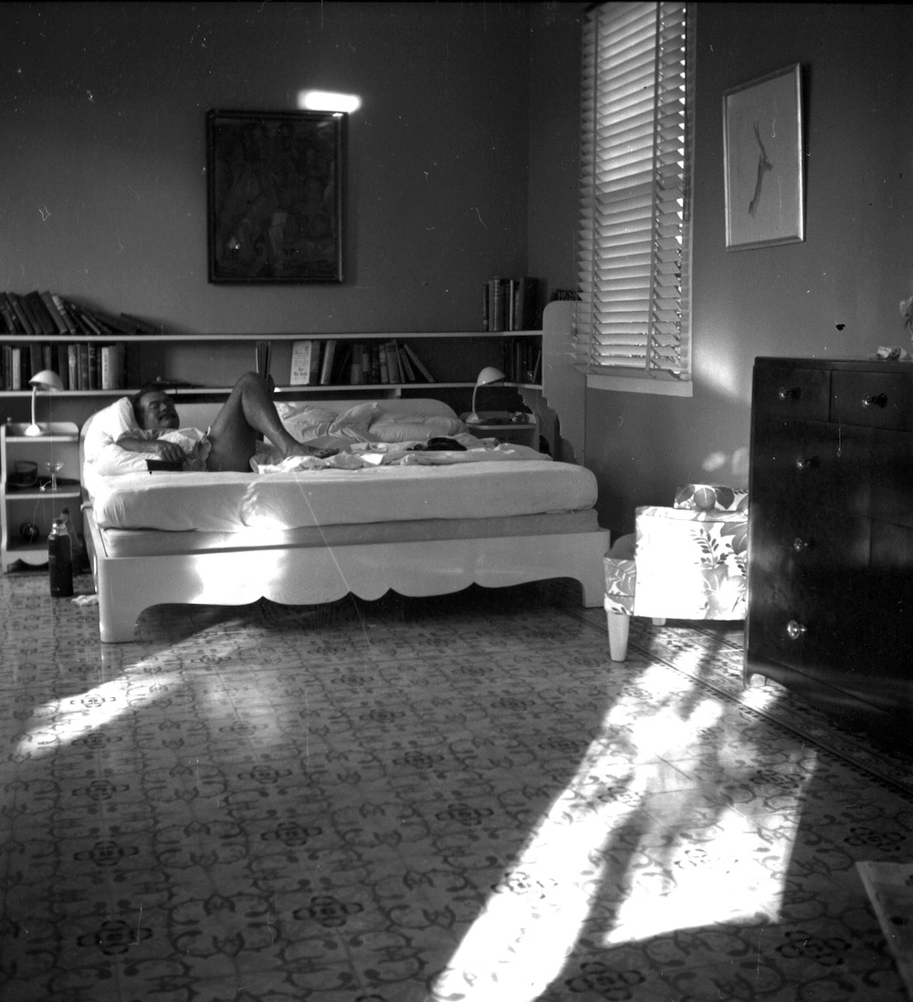EH1963N nd. Ernest Hemingway lying on a bed in bedroom. Finca Vigia, Cuba. Please credit: Ernest Hemingway Collection at the John F. Kennedy Presidential Library and Museum, Boston.