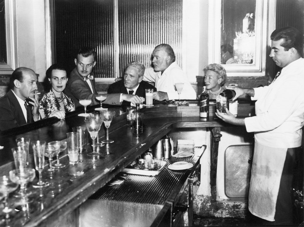 EH 5084P not dated, ca. 1955 La Floridita, Havana, Cuba. Roberto Herrera, Byra "Puck" Whittlesey, John "Bumby" Hemingway, Spencer Tracy, Ernest Hemingway, and Mary Hemingway. Please credit: "Ernest Hemingway Photograph Collection, John Fitzgerald Kennedy Library, Boston."
