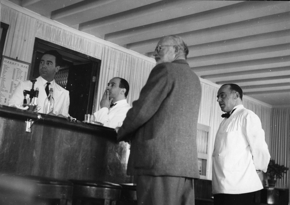 EH3721P 1949 Ernest Hemingway and waitstaff at Harry's Bar. Please credit "Ernest Hemingway Photograph Collection in the John F. Kennedy Presidential Library and Museum, Boston."