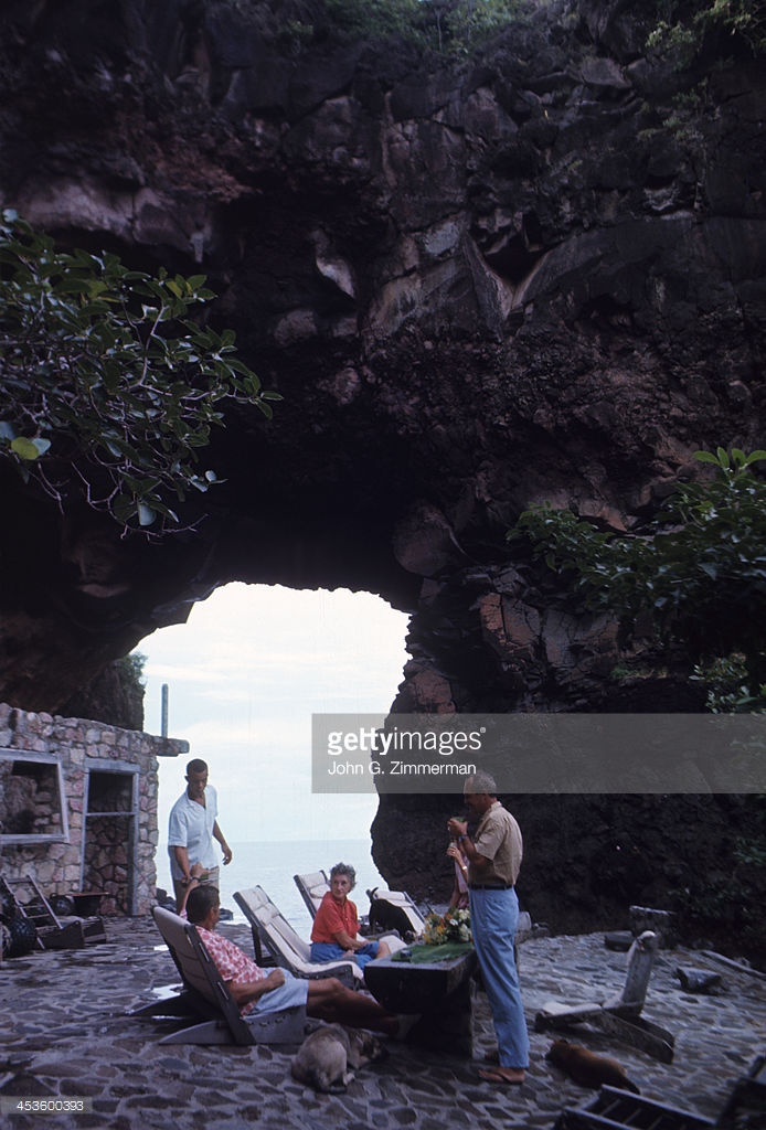 Sports Architecture: Tom Johnston and his wife, Gladys, with guests on the roof of their volanic house called Moonhole. The couple is building a multi-layered home out of lava, whale ribs, and mortar. Bequia, Saint Vincent and the Grenadines 11/20/1966 CREDIT: John G. Zimmerman (Photo by John G. Zimmerman /Sports Illustrated/Getty Images) (Set Number: X12055 )