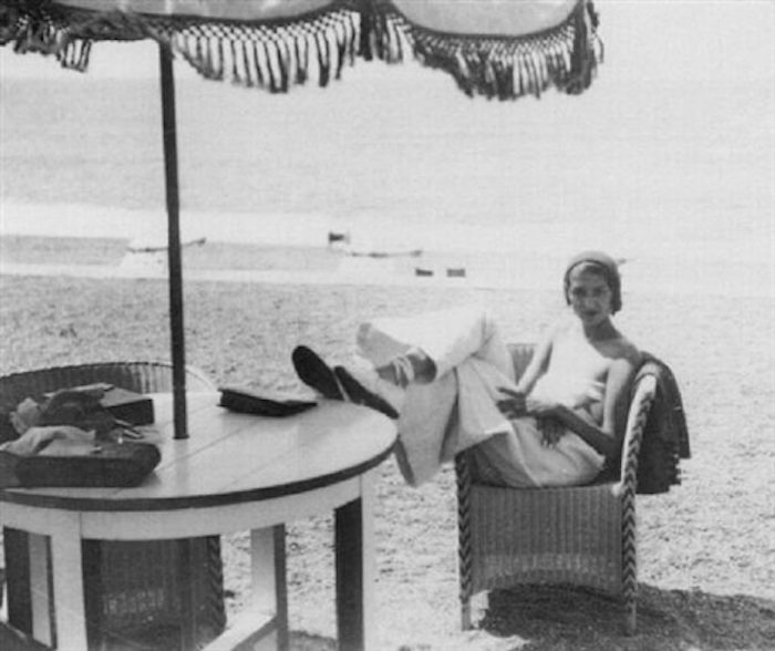 jacques-henri-lartigue-renee-perle,-in-cane-chair-under-sun-umbrella,-biarritz